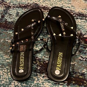 Trendy. Chic. Fashionable gold pointy studded black sandal. Size 40
